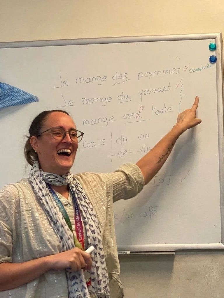 Mathilde teaching a live French lesson in Sydney — breaking down sentence 
structure on the whiteboard, one check mark at a time. Book a trial lesson 
and see how it feels to actually enjoy learning French.