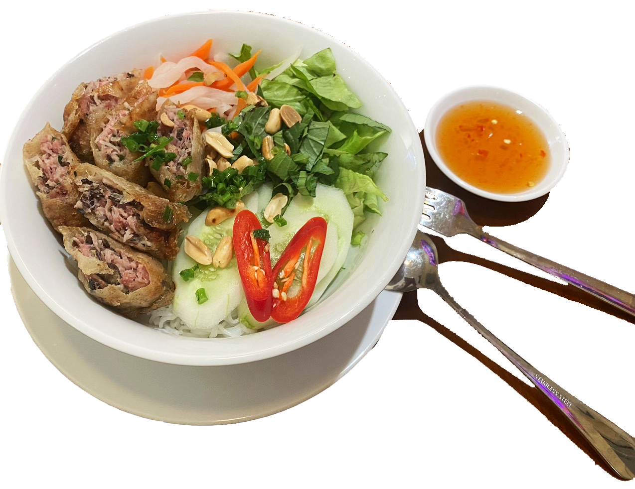 A bowl of Vietnamese spring rolls with fresh vegetables, herbs, and sliced chili peppers, served with a side of dipping sauce, paired with a fork and spoon.