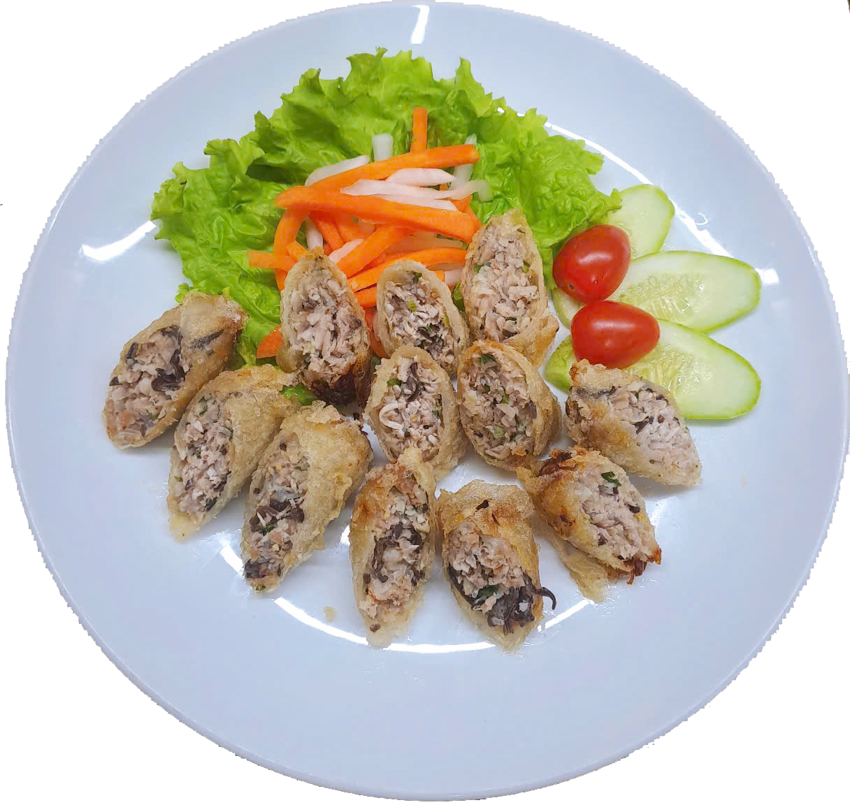 Plate of sliced fried spring rolls filled with meat and vegetables, served with lettuce, shredded carrots, sliced cucumber, and cherry tomatoes.