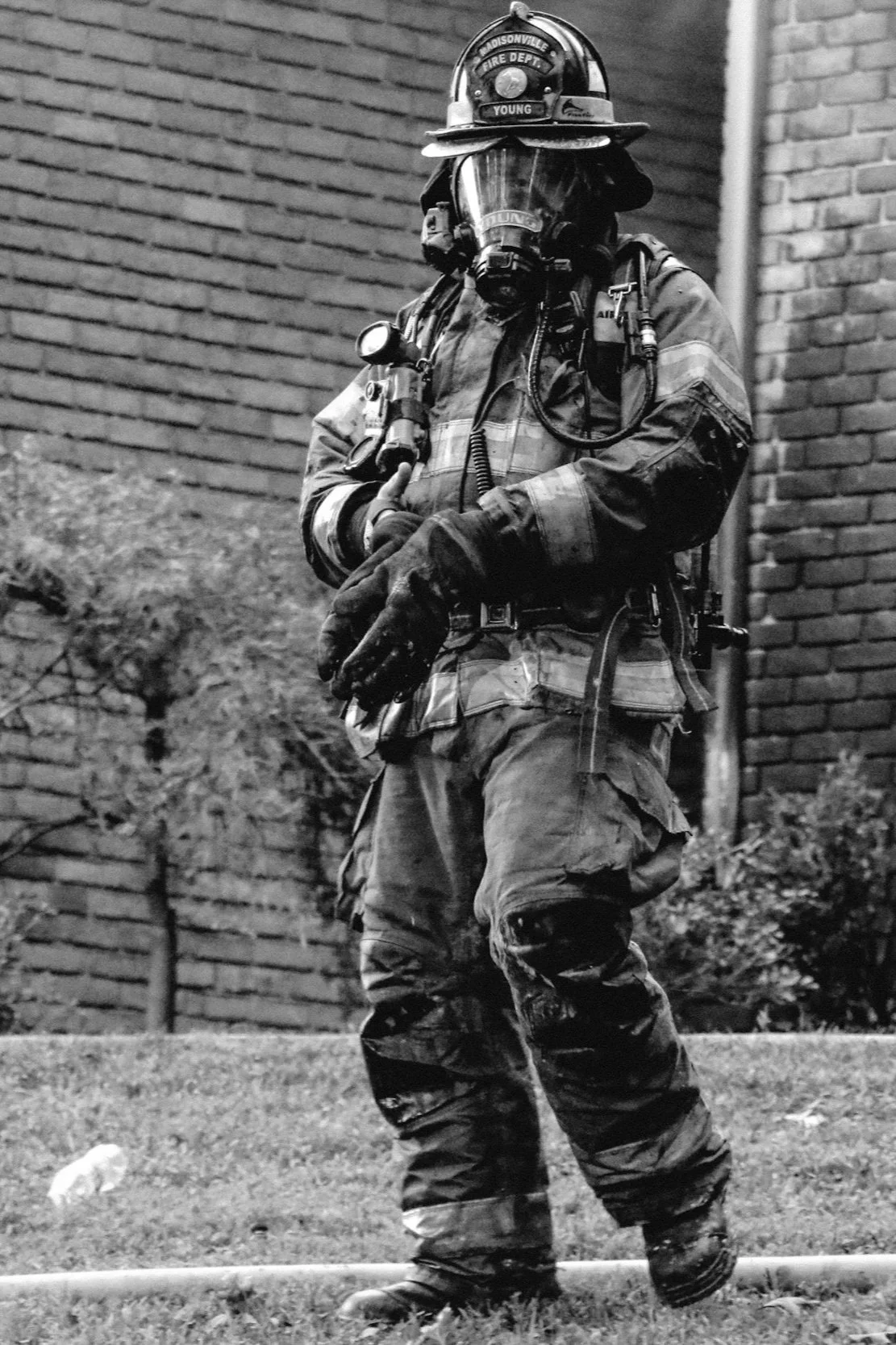 Black and white photo of firefighter in full firefighter gear