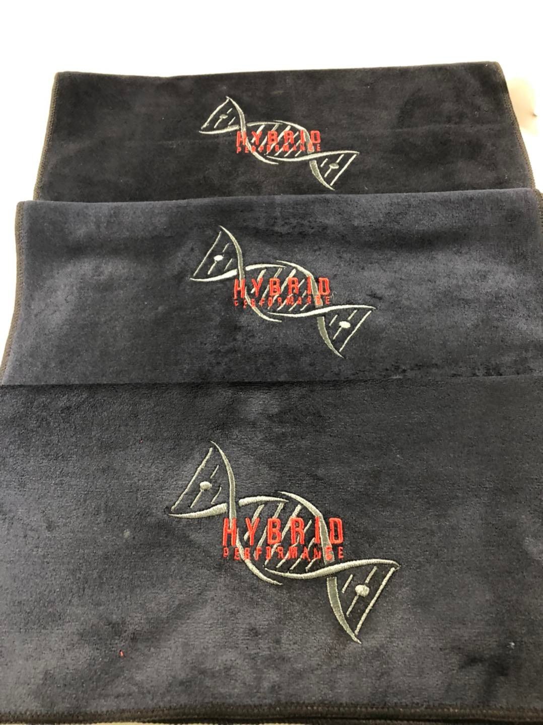 Three black fabric headbands with embroidered logo reading 'HYBRID PERFORMANCE' and a DNA double helix design.