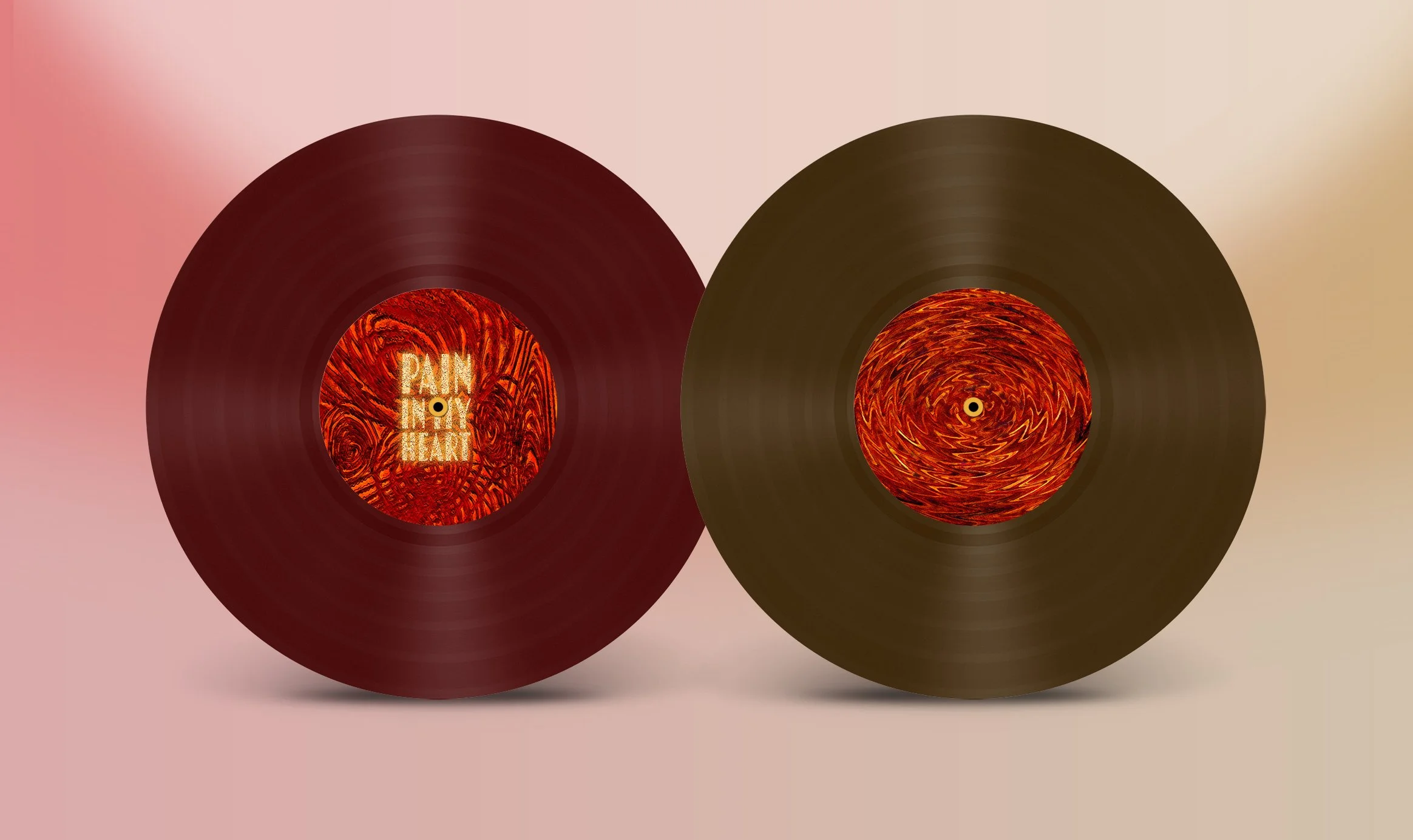 Two vinyl records with red and orange swirl patterns on the labels, one with the text 'Pain In My Heart.'