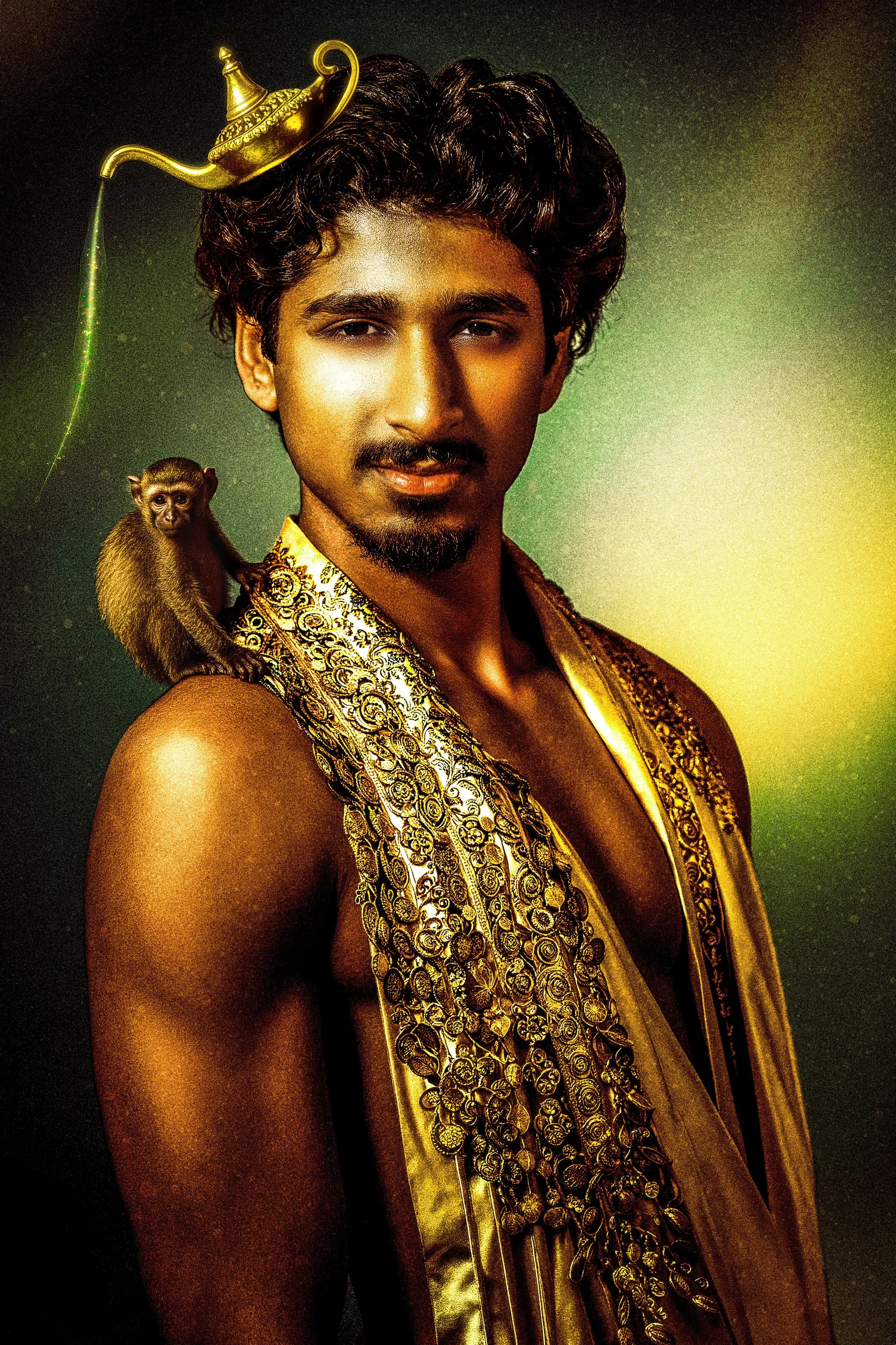 A man with dark, curly hair and a mustache wearing traditional Indian attire, with a small monkey perched on his shoulder and a golden lamp on his head.