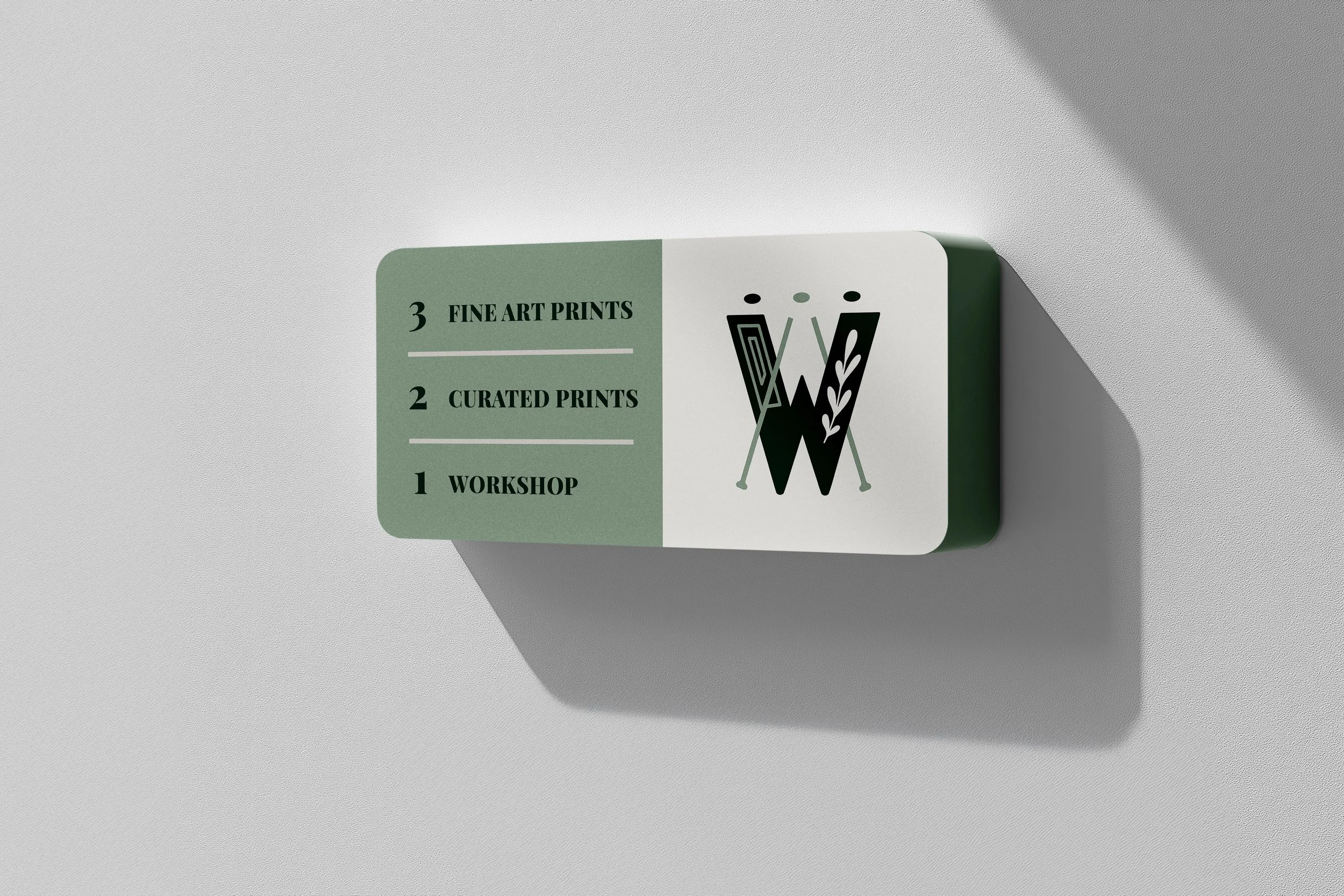 Signboard with a green and white background, displaying three offerings: workshop, curated prints, and fine art prints, with a stylized abstract fern design.