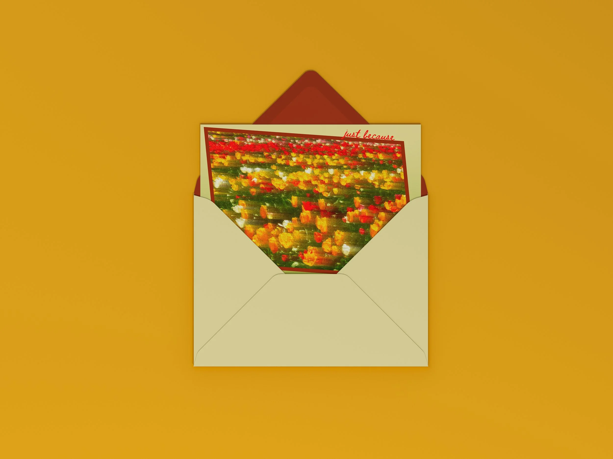 An envelope containing a card with a blurry floral image of multicolored tulips and the partial text 'just because' visible at the top.