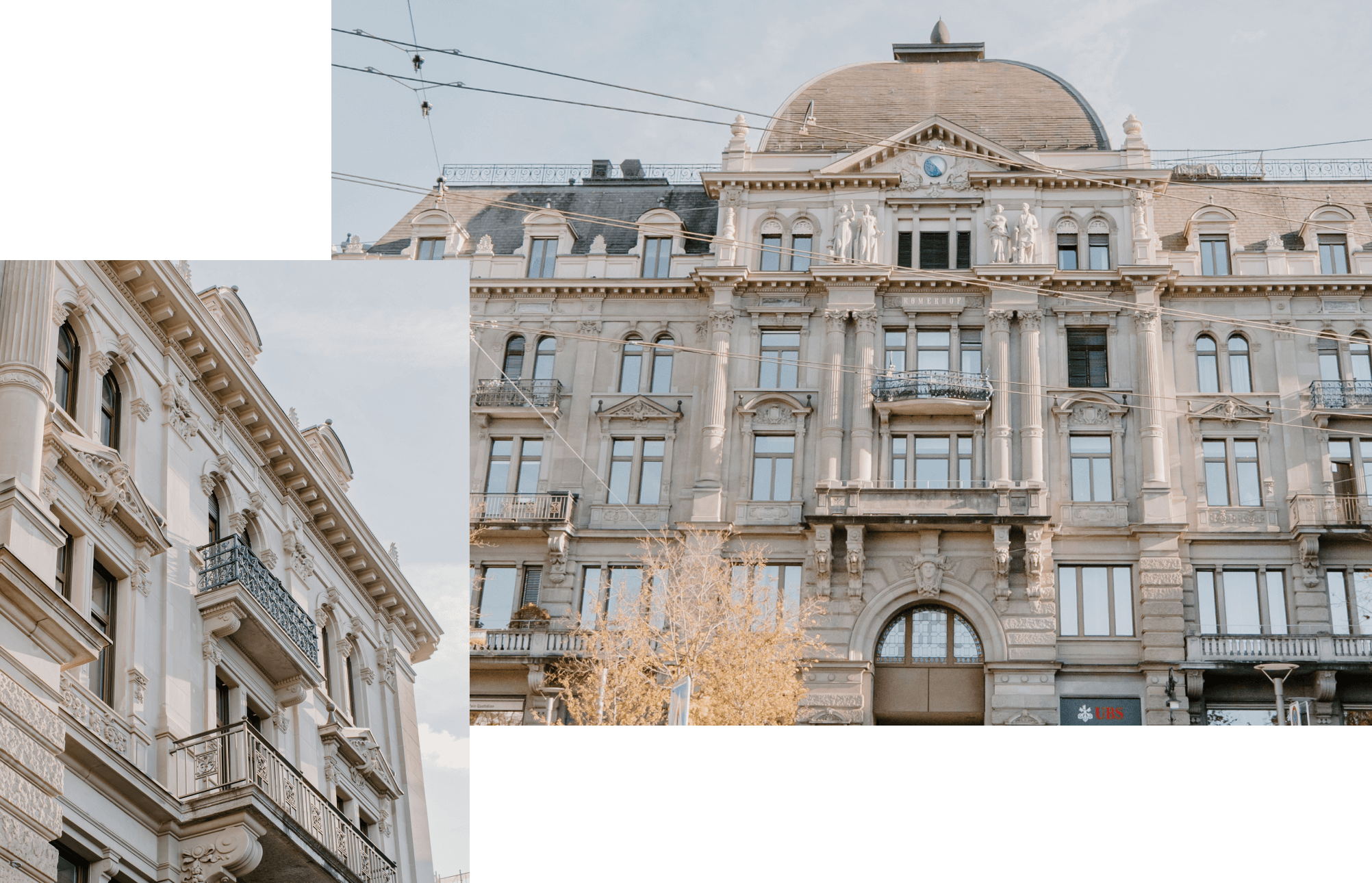 Two ornate historic buildings with decorative architectural details, balconies, arched windows, and classical elements; one has a dome and a clock. The sky is clear, and there are overhead tram wires.