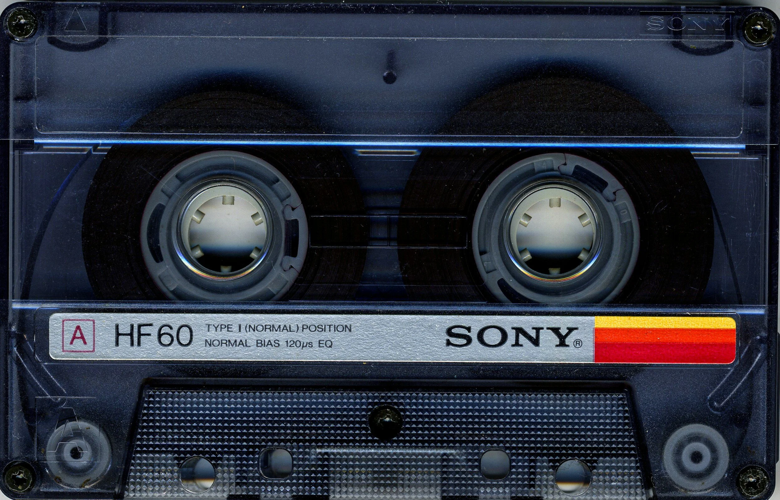 Close-up view of a Sony HF60 compact cassette tape, showing the reels and label with branding and specifications.