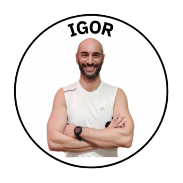 A smiling man with a bald head and beard, wearing a white sleeveless shirt and a watch, standing with arms crossed in front of a white background with the name 'IGOR' above him.