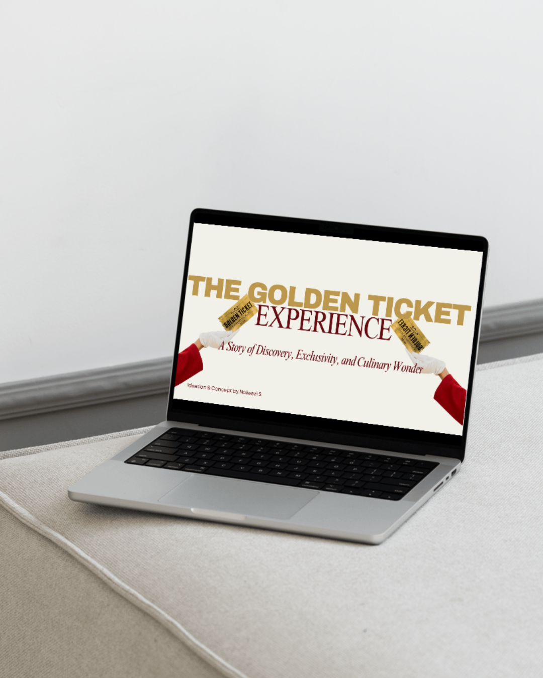 Laptop on a beige surface displaying a presentation titled 'The Golden Ticket Experience' with a subtitle 'A Story of Discovery, Exclusivity, and Culinary Wonder,' featuring two arm illustrations holding golden tickets.