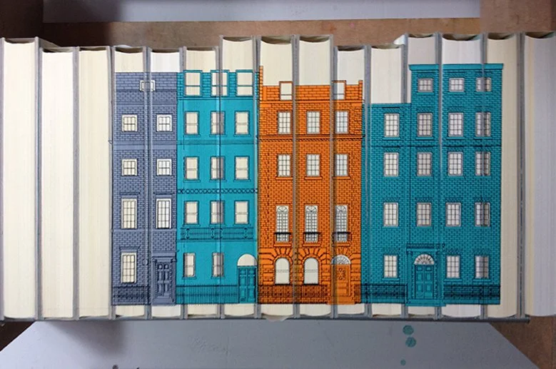 Books with colorful covers designed to resemble city buildings.