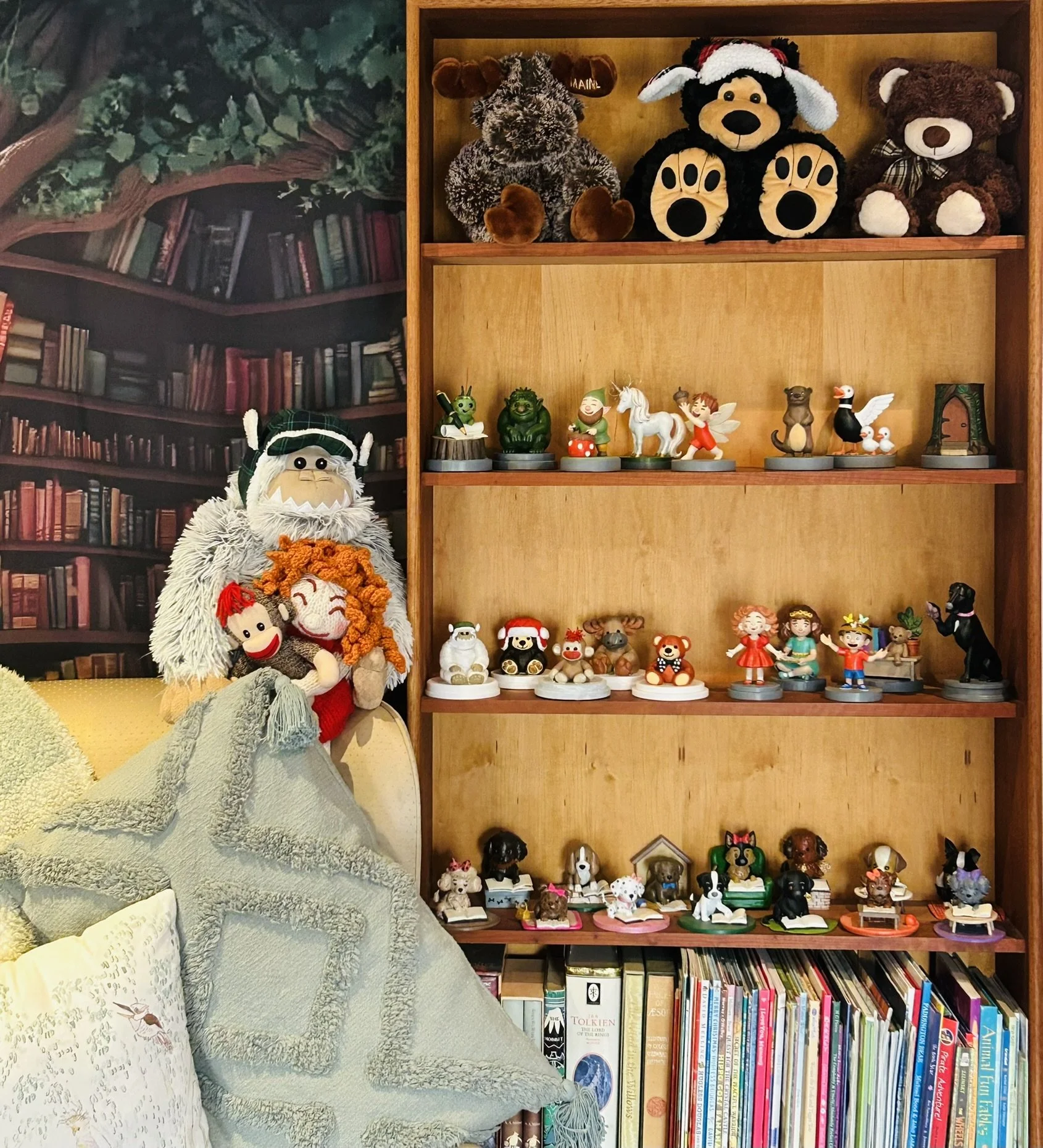 Cosy reading nook from Story Time With Ninny with a chair, bookshelves, Puppy Page Turner and character models and soft toys.