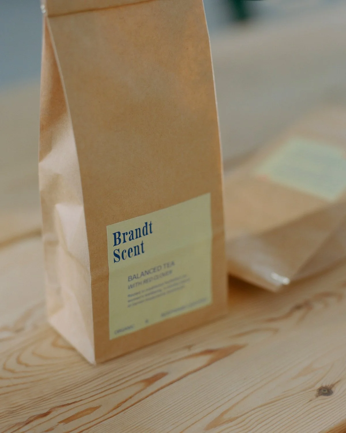 A brown paper bag with a light yellow label that reads "Brandt Scent" and "Balanced Tea wit red clover"