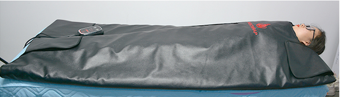 Person lying inside a sleeping bag on a mattress.