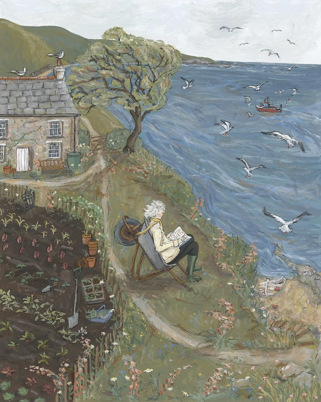 Original painting by Anna Neima. Rowena Cade, a woman with white hair reading while sitting in a chair on a hillside overlooking the ocean in Cornwall, with a house and a garden nearby, and seagulls flying over the water with a boat in the distance.