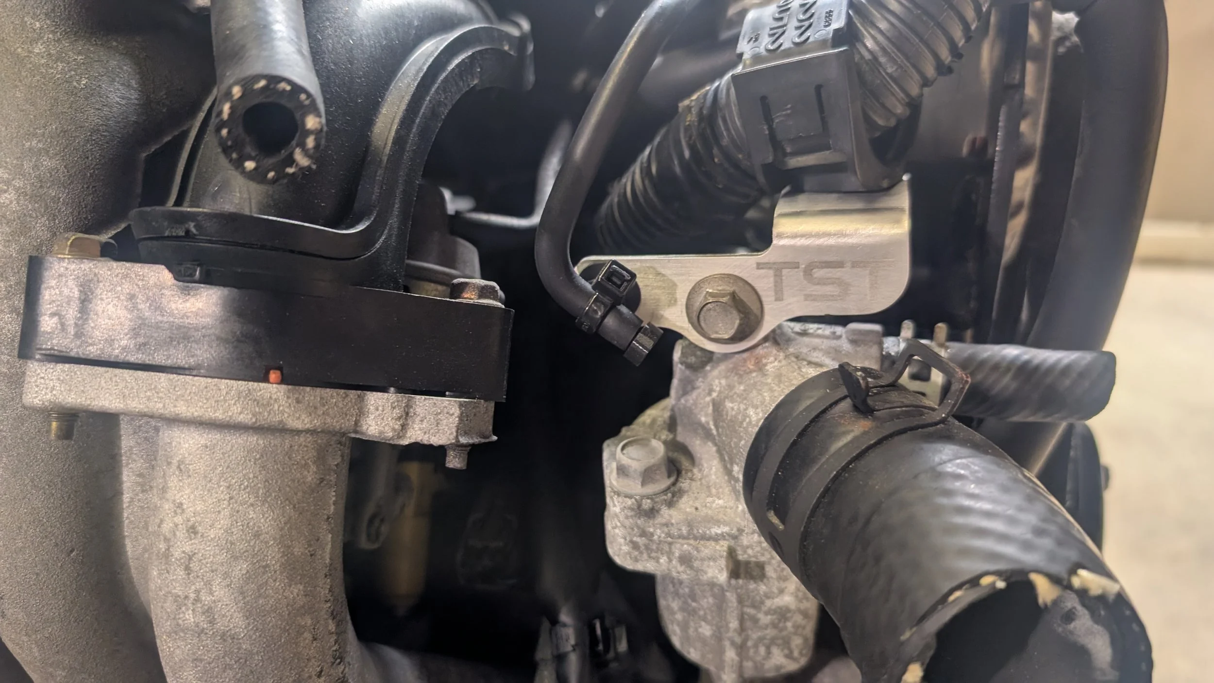 Harness and vacuum hose bracket installed