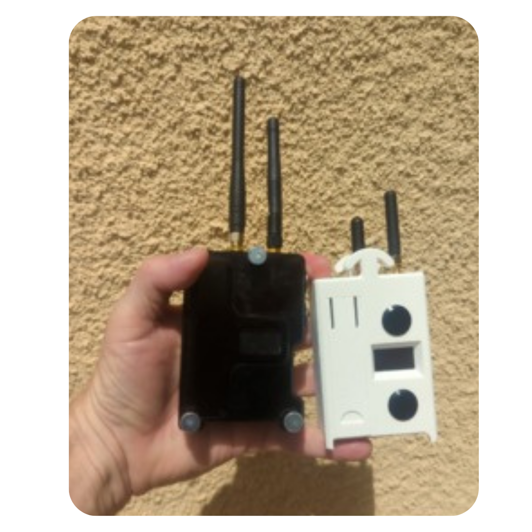 A hand holding two wireless communication devices with antennas, one black and one white, against a beige textured background.