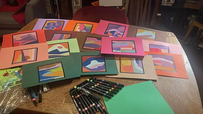 Paint pens on coloured paper.