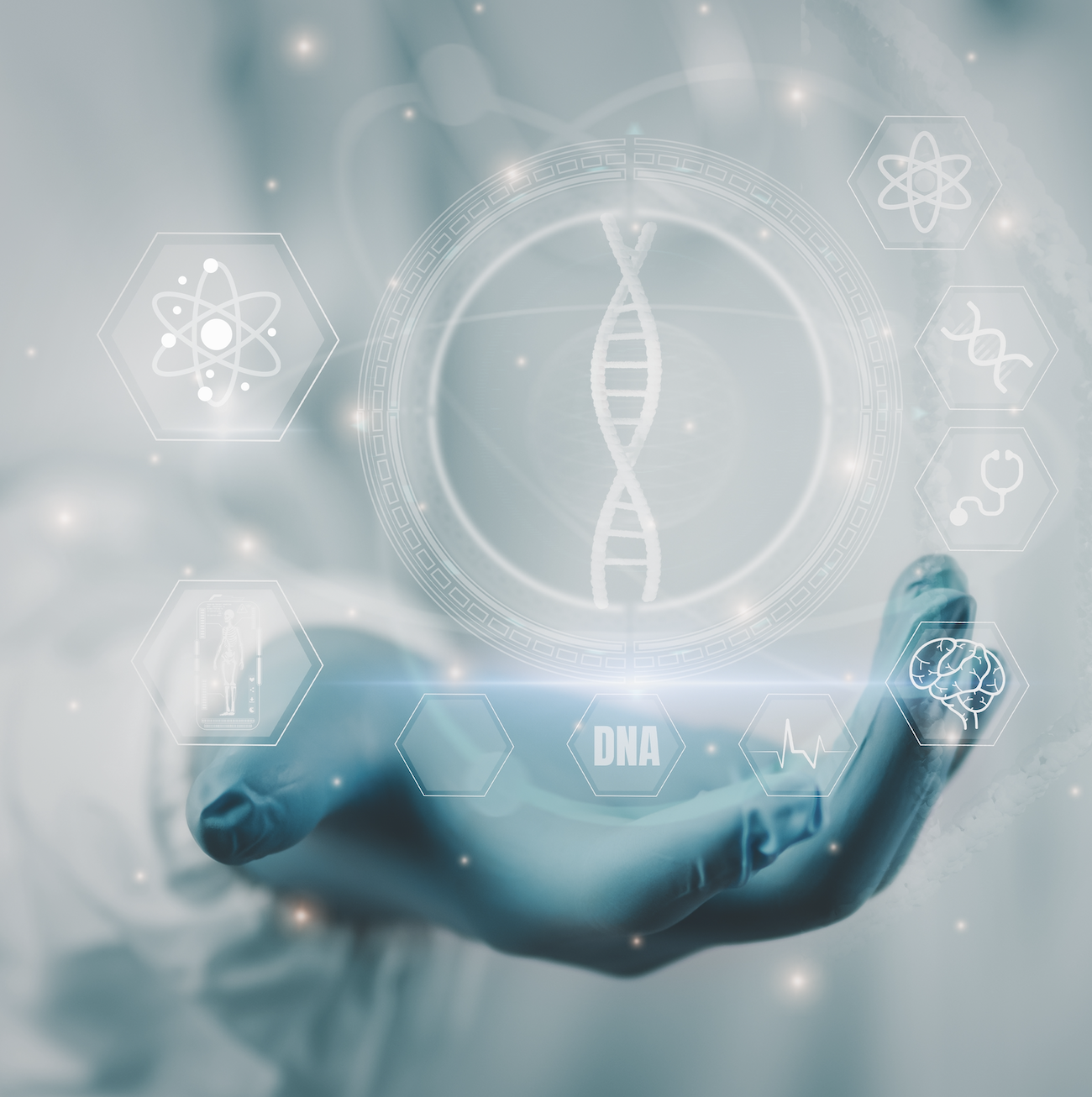 A hand holds a digital hologram of a DNA double helix with various science and health icons surrounding it, including atoms, a human body scan, brain, and medical symbols.