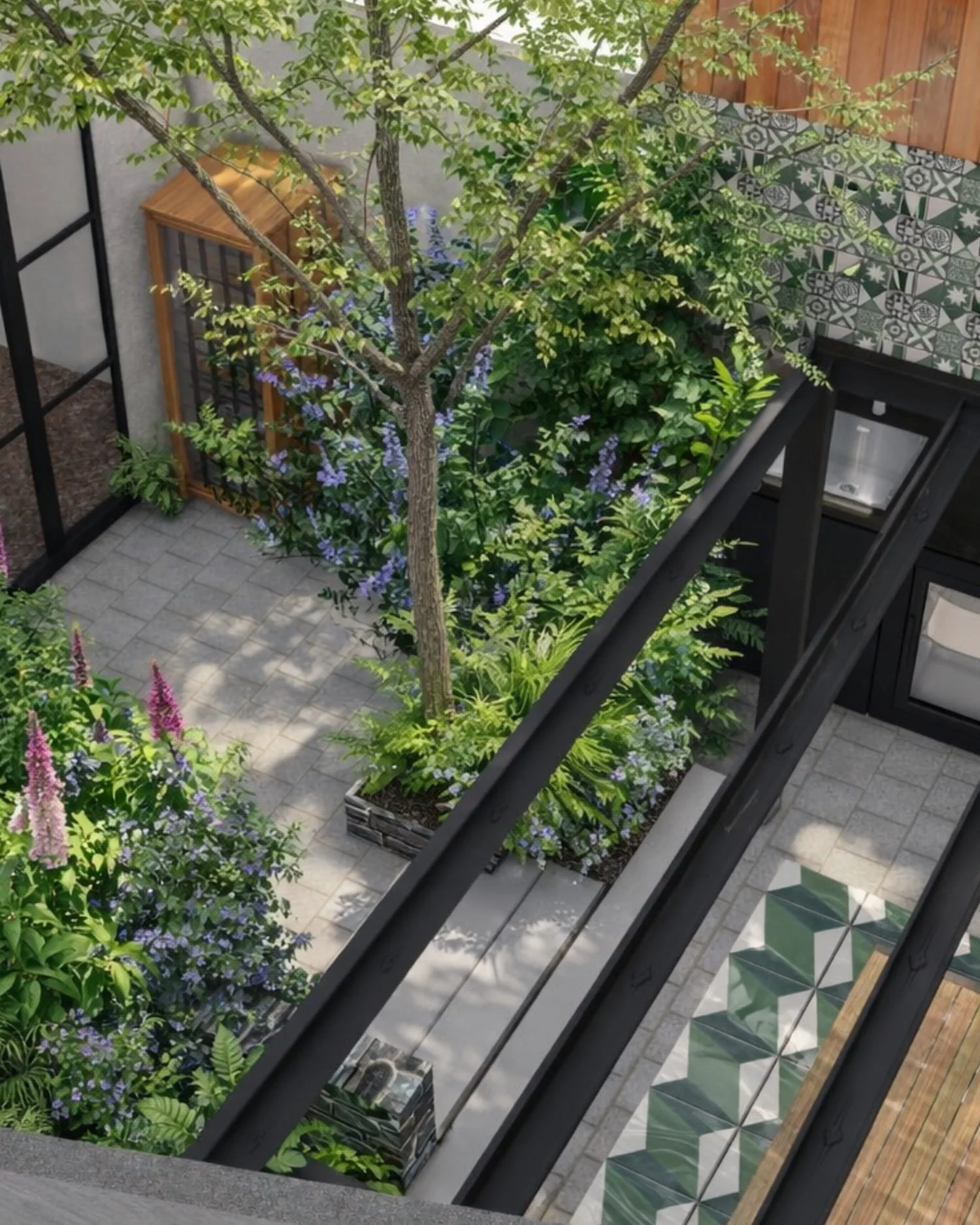 Designed courtyard garden with structural tree planting, layered borders and contemporary paving