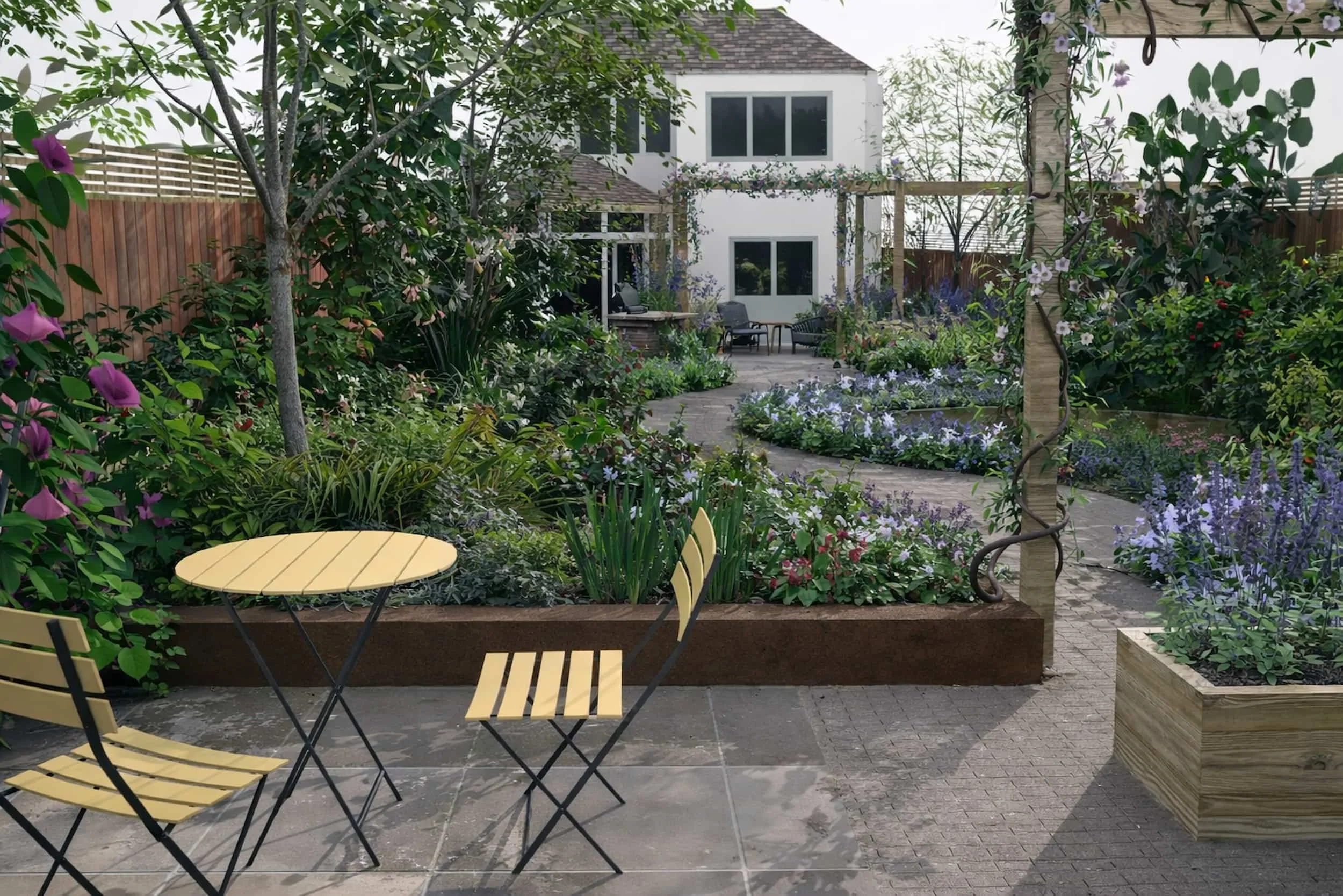 Looking forwards the house from a small seating area with a curved pathway