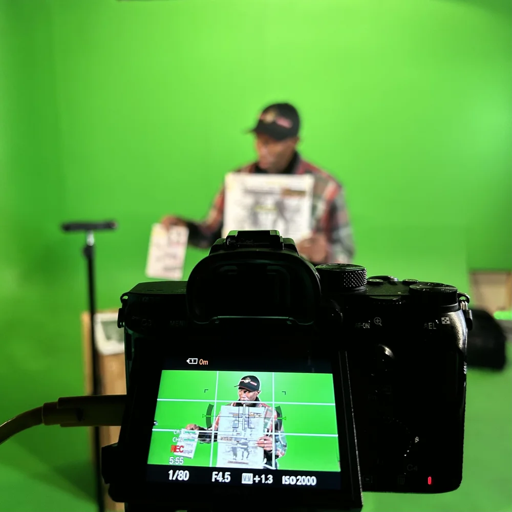 Camera monitor framing talent on a green-screen set during a 4 Snaps Productions shoot