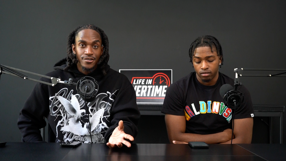 Two hosts on a podcast set produced at the 4 Snaps studio