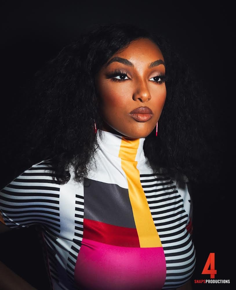 Fashion portrait of a woman in a colorful striped jacket