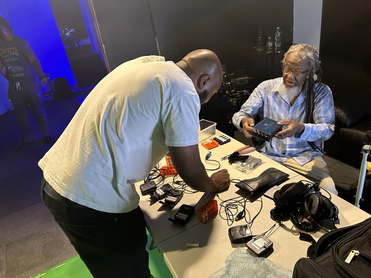 Production team prepping camera and audio gear before a shoot