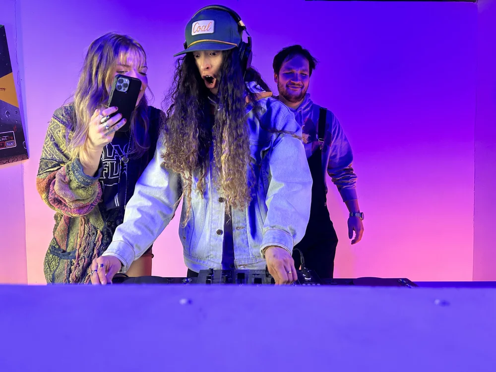 Talent and creatives on set under purple studio lighting