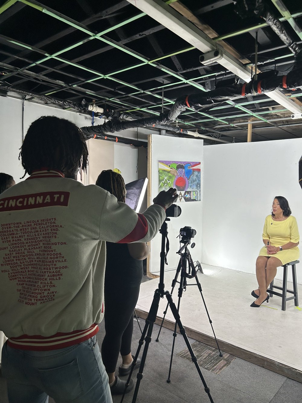 4 Snaps Productions camera operator filming an interview on set in the Cincinnati studio