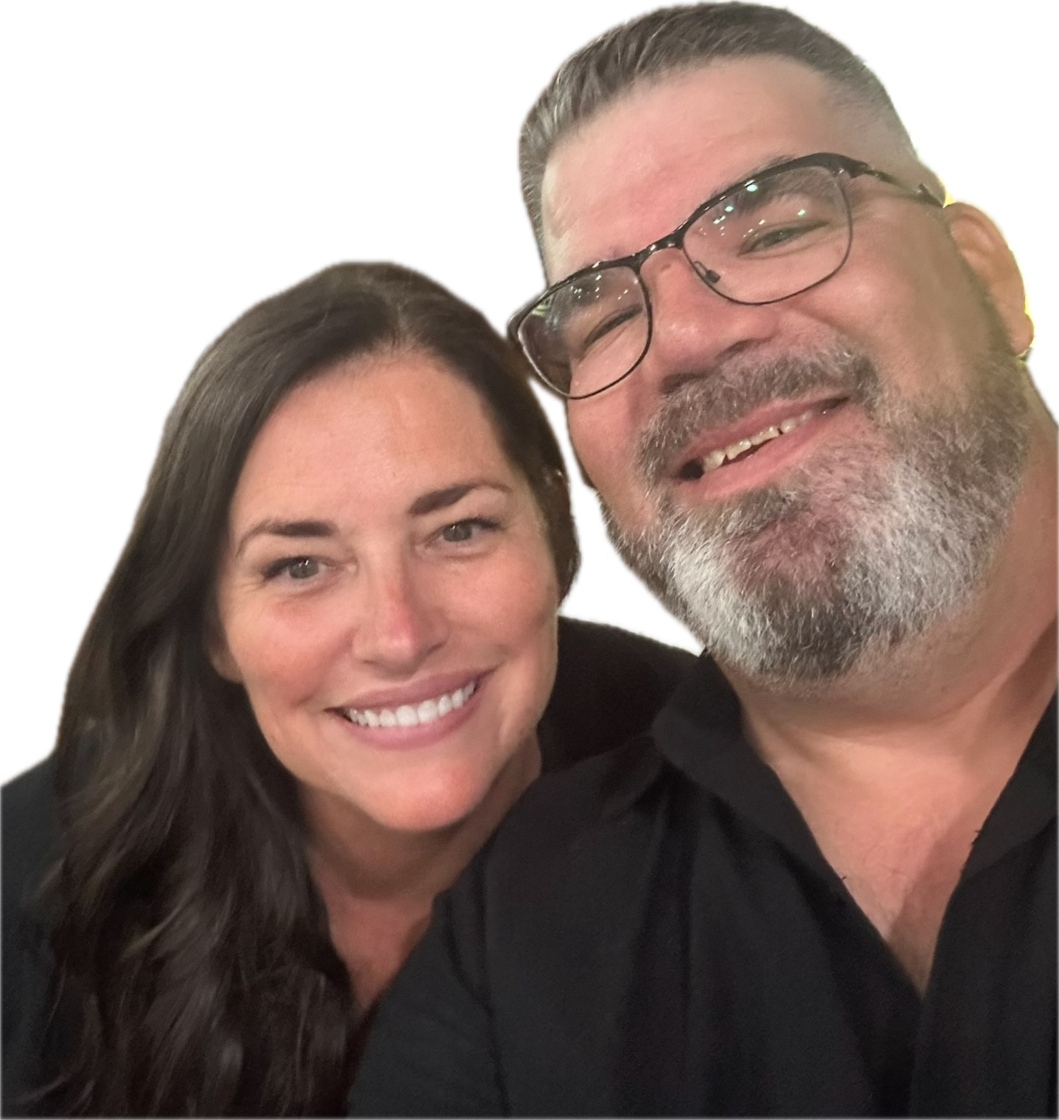 A smiling woman with long dark hair and a man with glasses, gray beard, and mustache, both taking a selfie together.