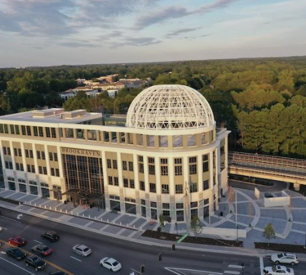 City hall in Brookhaven, Atlanta, located in a cityscape with trees and distant hills.