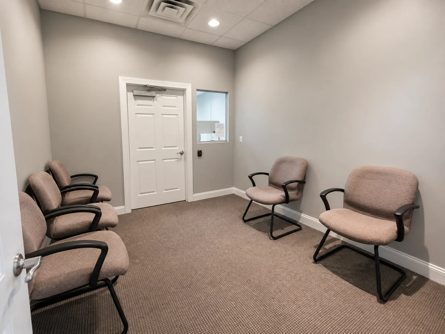Waiting Room with sliding glass window ready for a receptionist desk buildout to run your medical practice