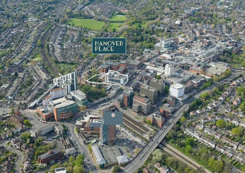 Aerial view of downtown Hanover Place, showing various buildings, roads, and green spaces in a cityscape.
