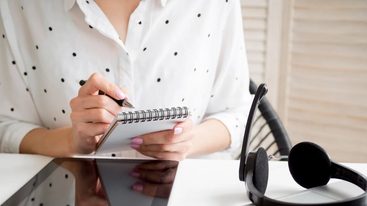 A woman writing down notes in a journal