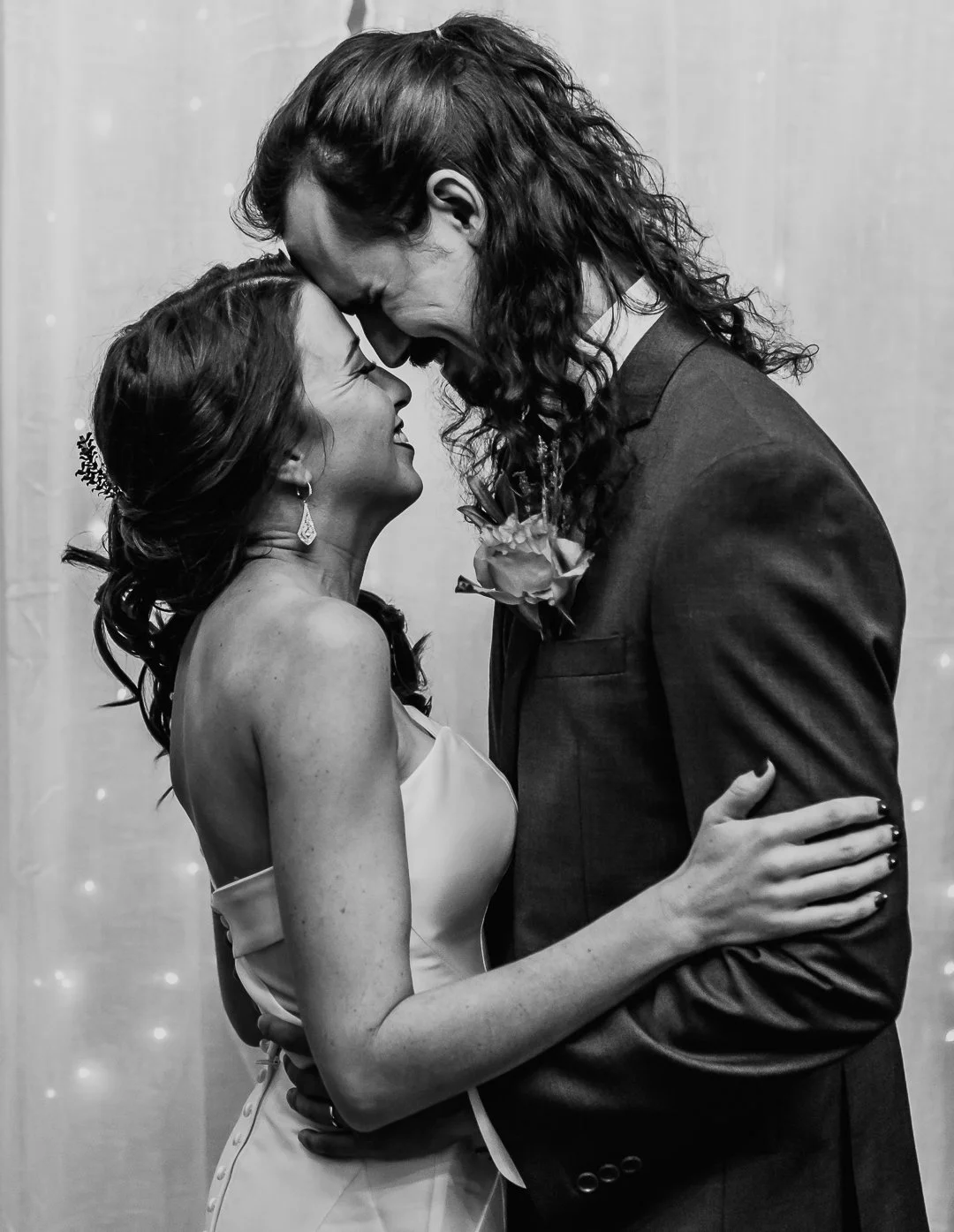 Black and white photo of a couple in formal attire, smiling with foreheads touching, at a wedding or special event | Videography and Photography | Evansville, IN