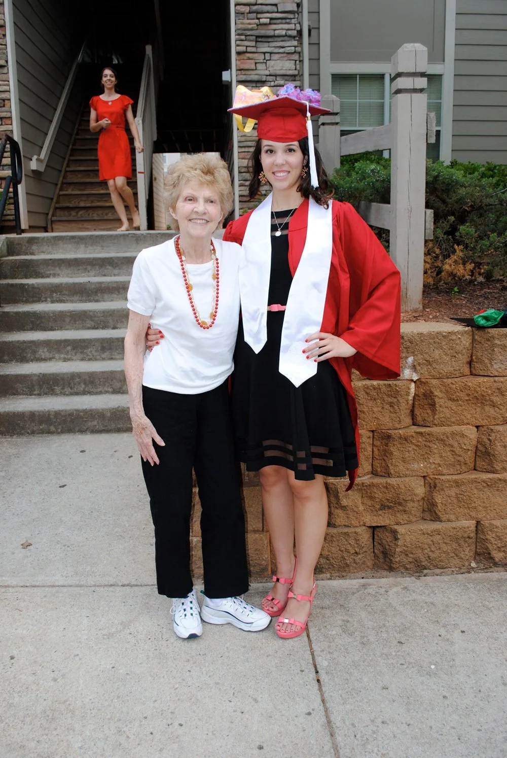 Graduation photo of Carly Marie with grandmother, showing personal journey and beginnings in beauty