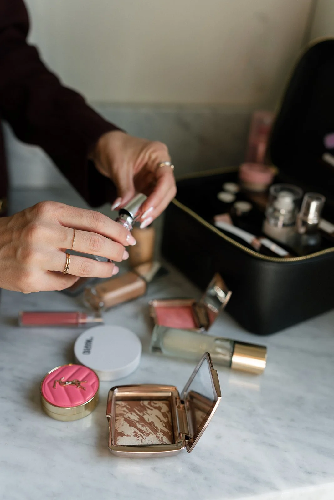 Flatlay of luxury bridal makeup products including blush and bronzer