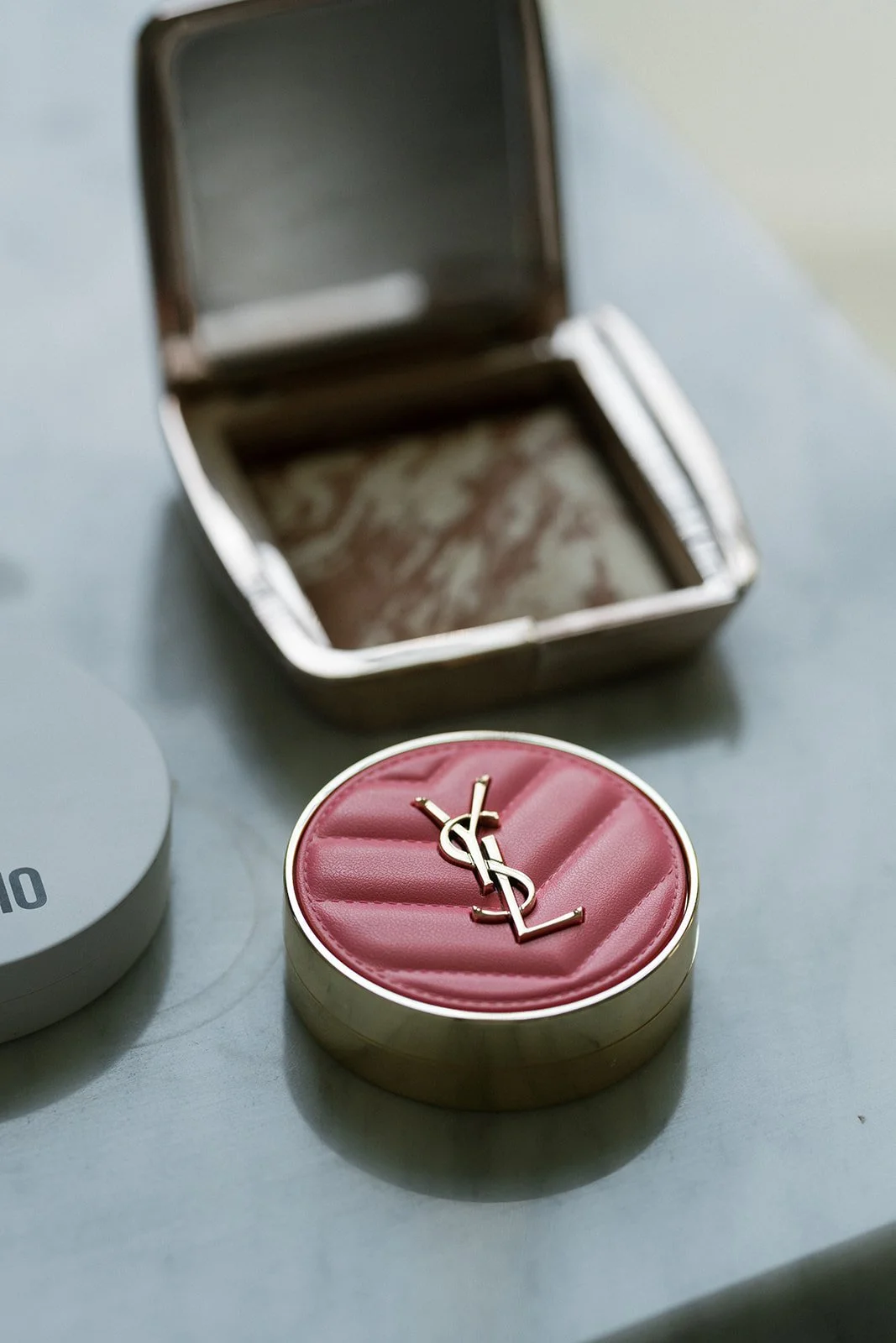 YSL blush and bronzer product flatlay — luxury bridal makeup kit used by Carly Marie Artistry