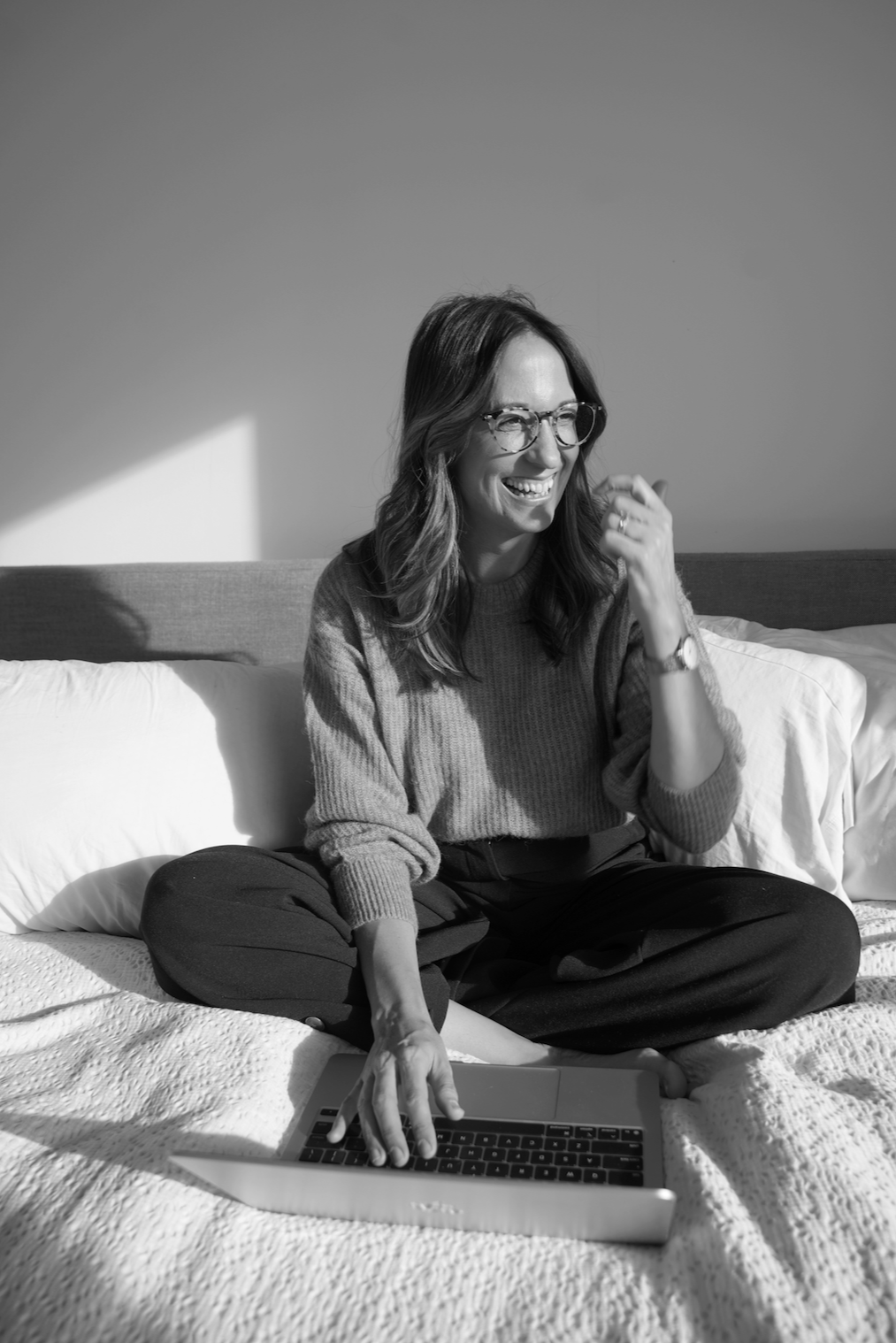 Anneke Foster, founder of We Tell Good Stories, working on a laptop.