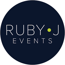 Ruby J Events logo with text in white on a dark blue circular background, featuring a small green dot.