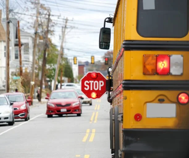 School bus with stop arm out on route