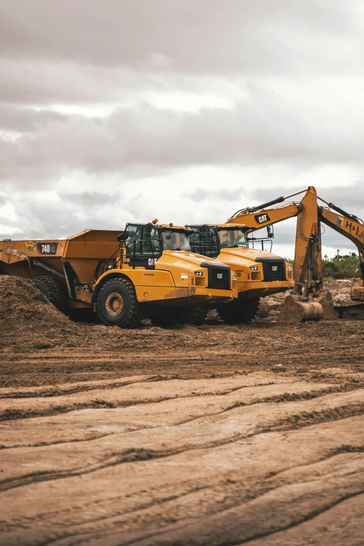 Two large heavy equipment units operating close to each other