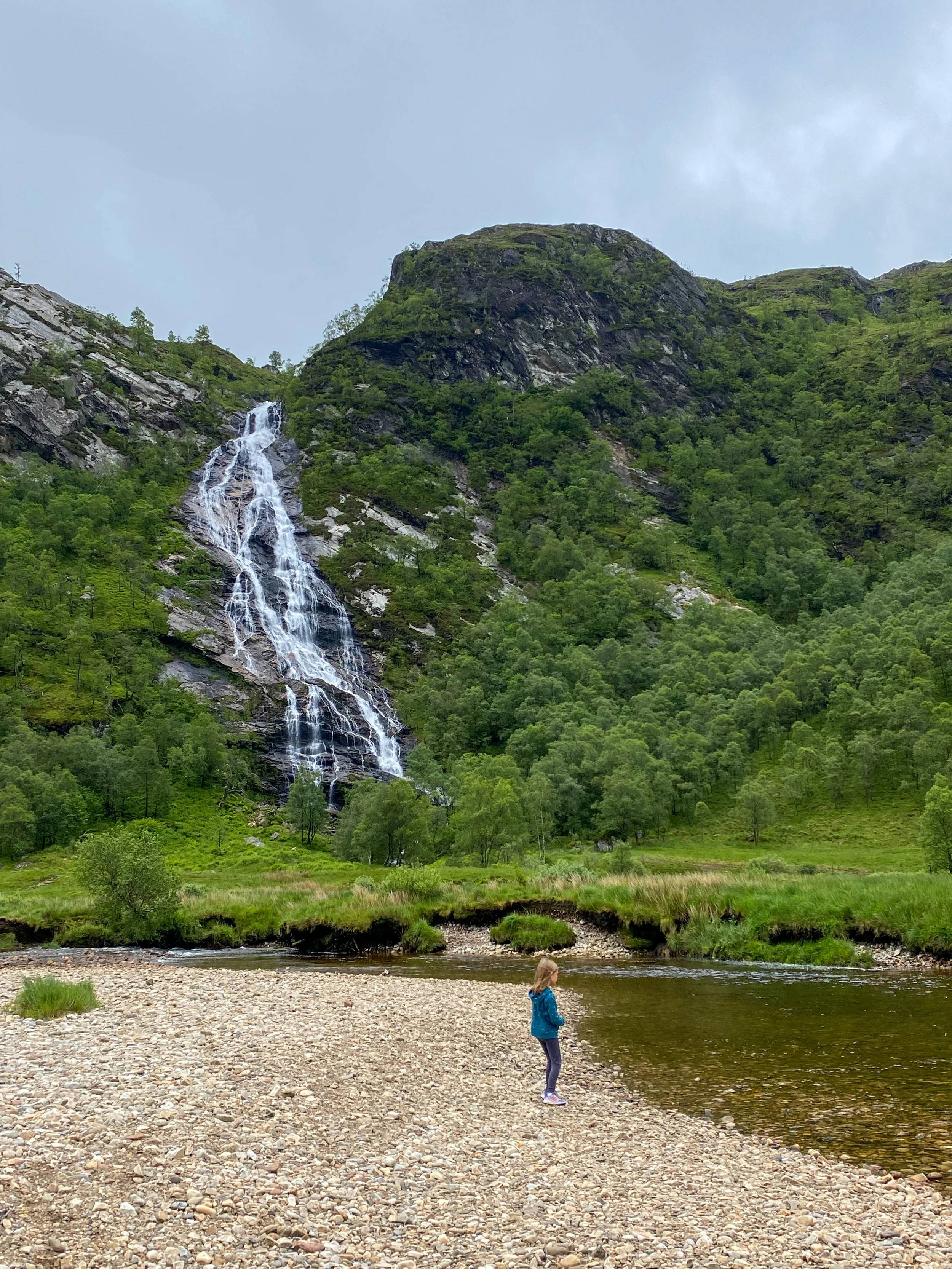 girl looking at Steall Waterfall, the background of quidditch games in the Harry Potter films