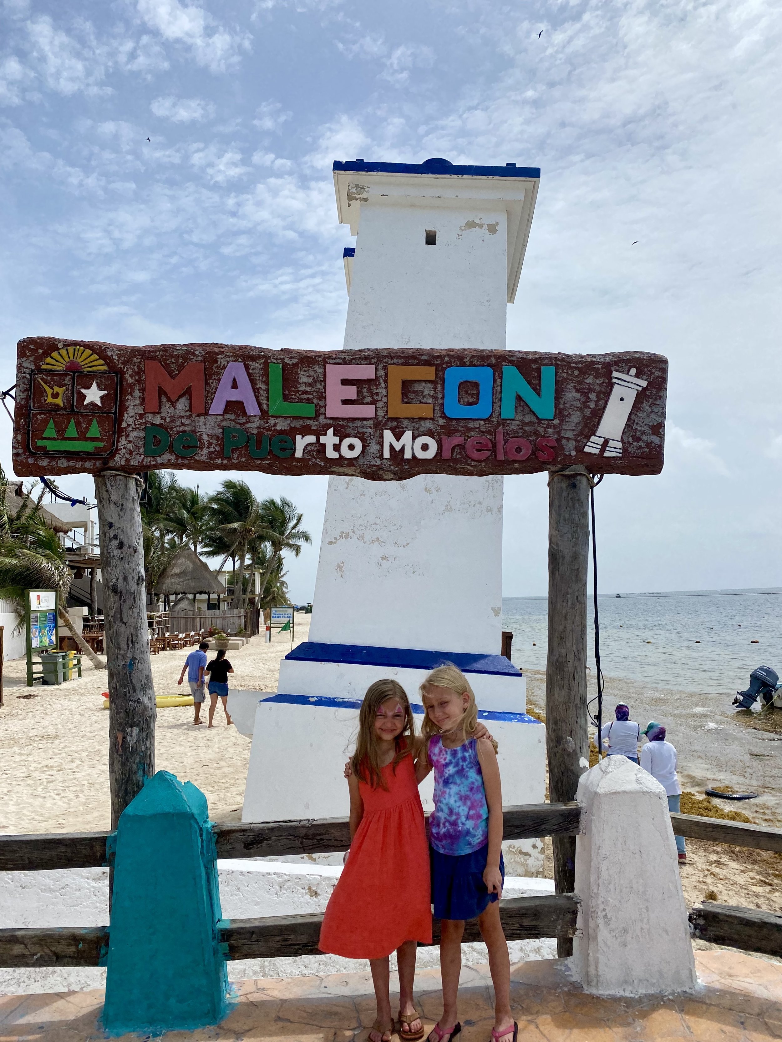 Standing in front of the crooked lighthouse in Puerto Morelos, Mexico