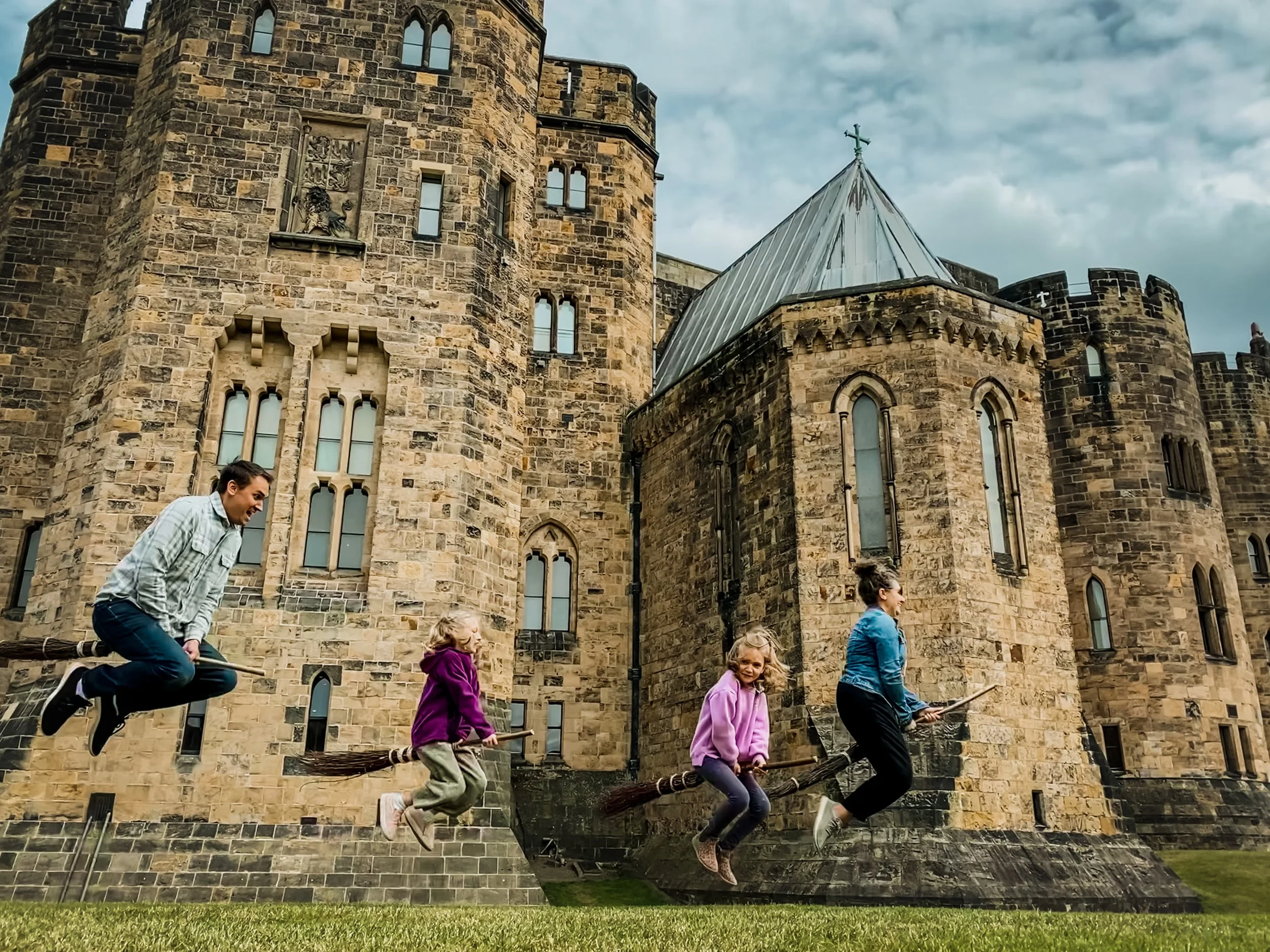 A family flying through broomstick lesson at Alnwick Castle, where Harry Potter learned to fly in the Harry Potter films.