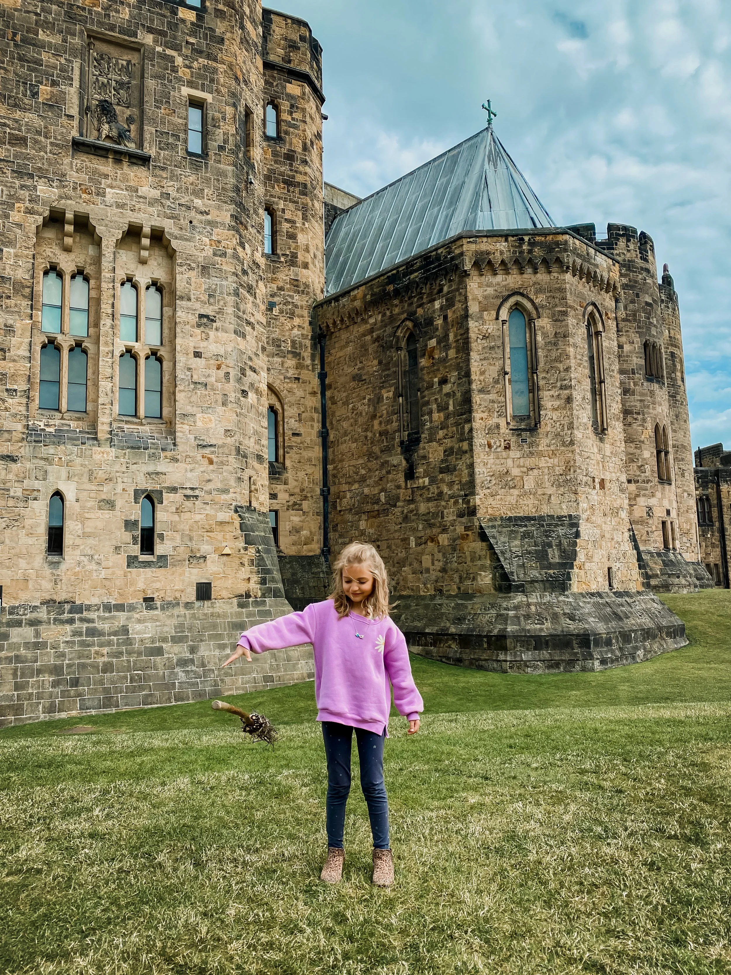 girl at Alnwick Castle commanding her broom "Up" where Harry Potter learned to fly in the Harry Potter films