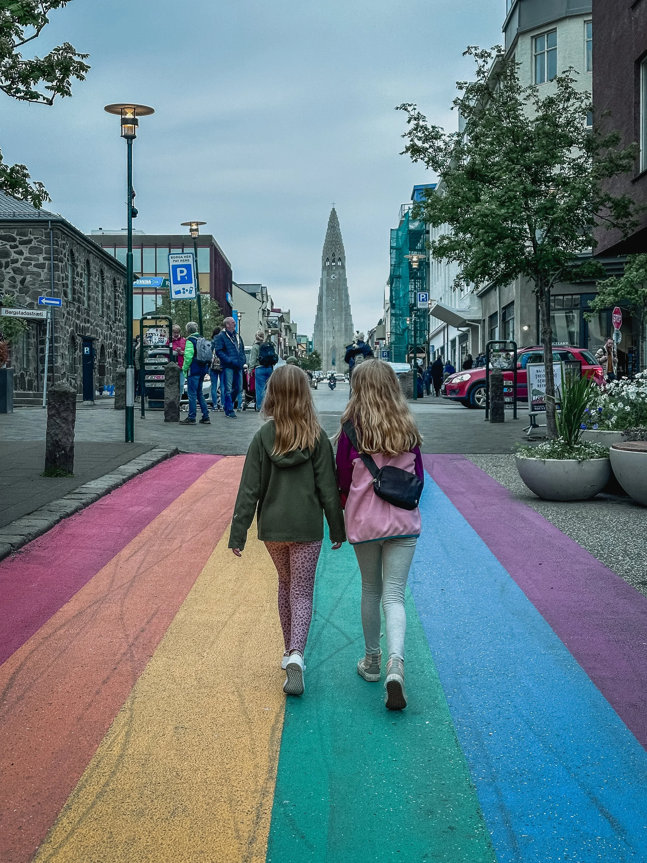 Two girls walking on the rainbow road in Reykjavik, Iceland