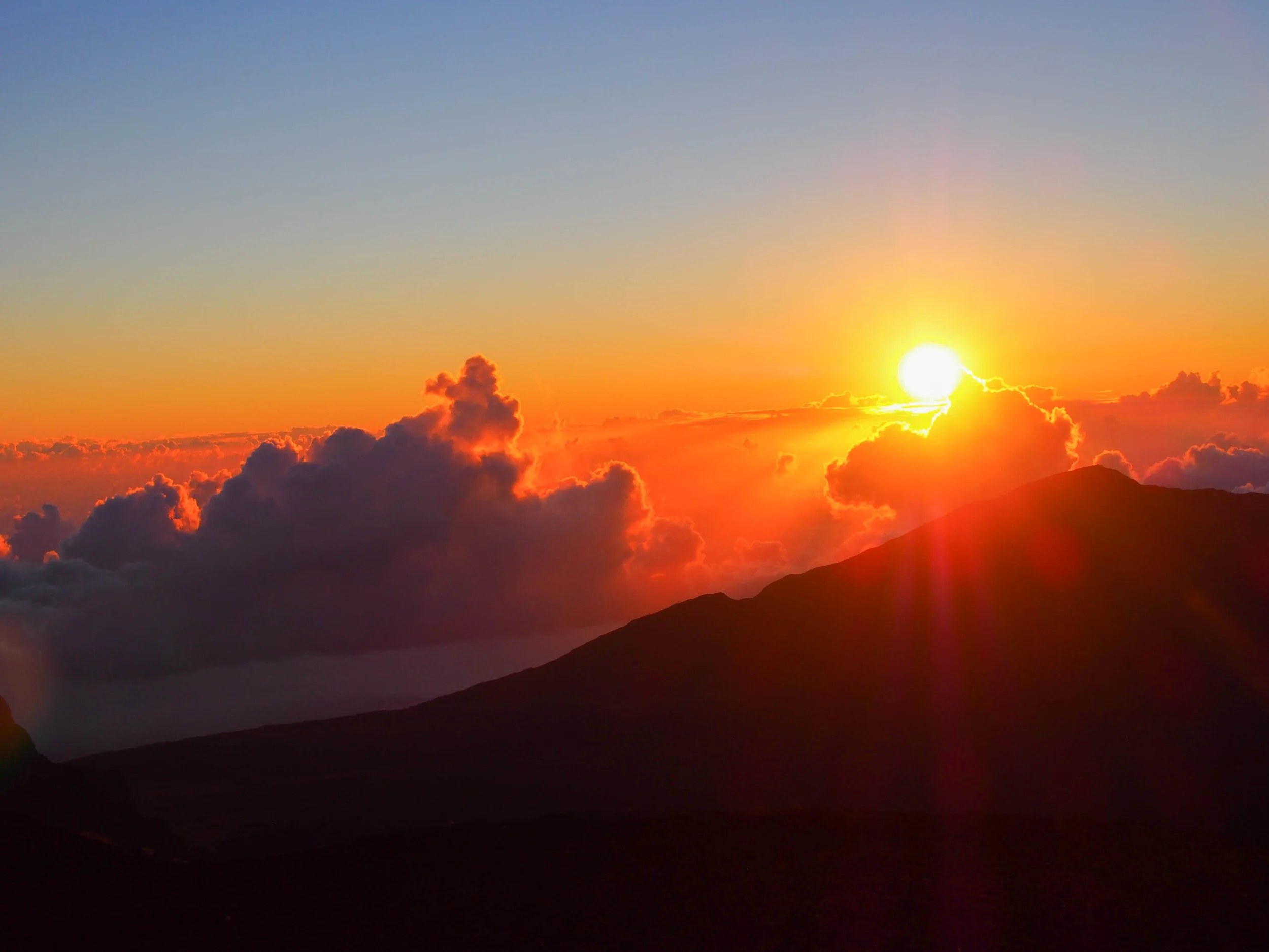 Sunrise over the clouds in Haleakala National Park, Maui, Hawaii