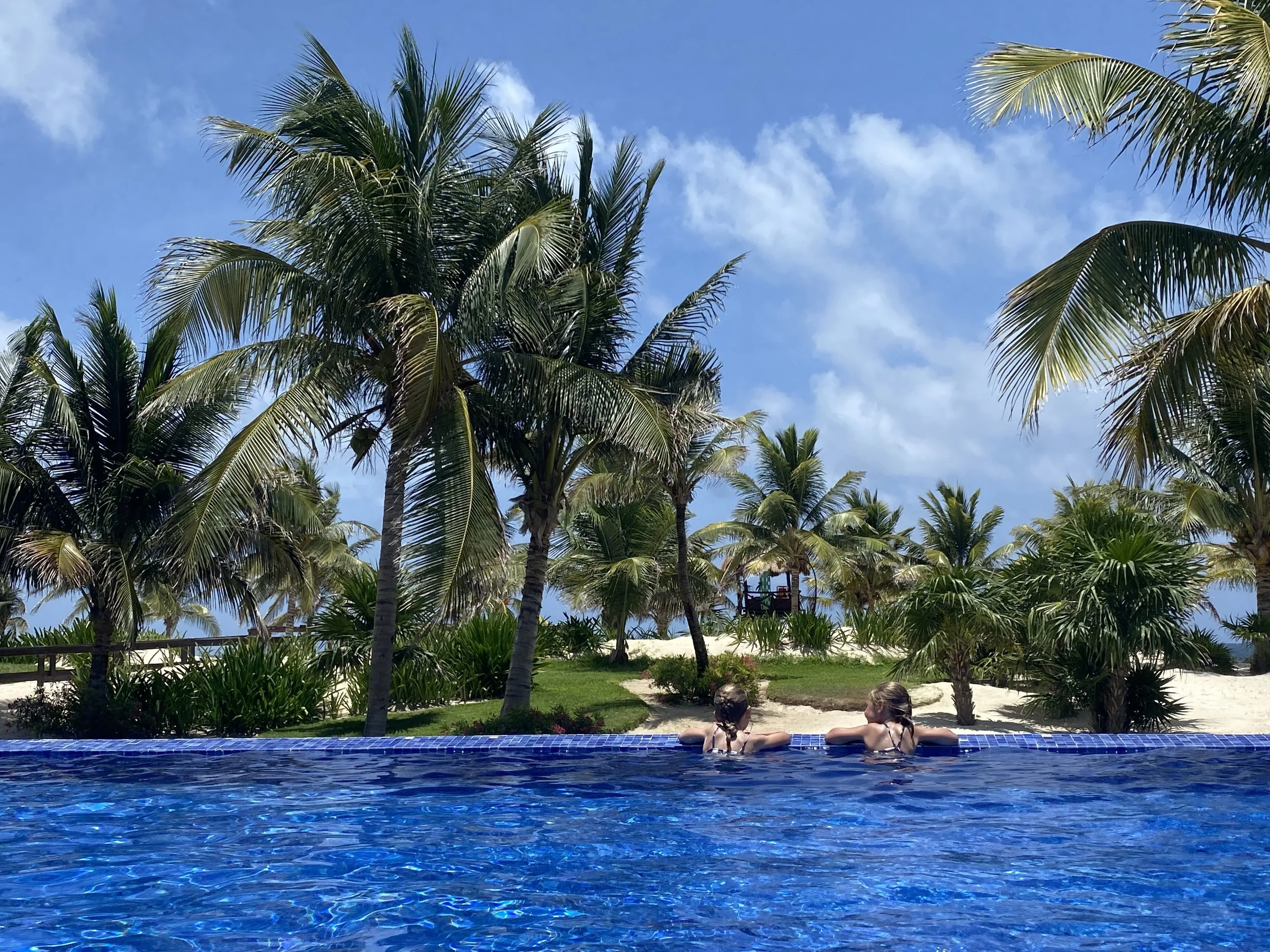 Admiring the view of the beach from the pool in Mexico